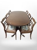 An eight piece reproduction mahogany dining room suite comprising of extending dining table,
