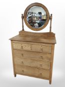 An Edwardian oak five drawer dressing chest with mirror back,