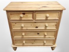 A contemporary pine five drawer chest,