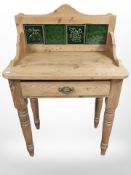 An Edwardian pine tiled backed wash stand,