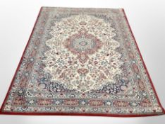 A machine made rug of Persian design 241 cm x 170 cm