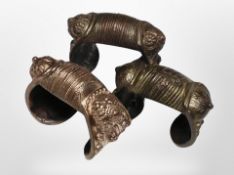 Three ornate brass bangles