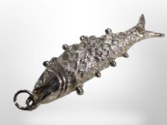 A white metal fish pendant