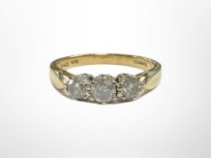 An 18ct gold three stone diamond ring, size L. CONDITION REPORT: 2.