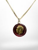 An enamelled 1915 silver three pence piece on gold plated chain