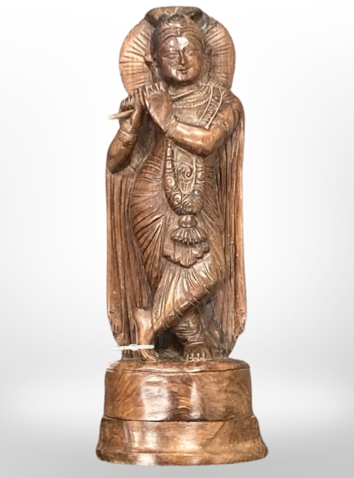 A finely carved hardwood figure of the Hindu god Krishna,