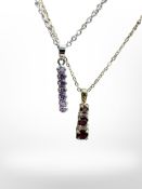 A Swarovski seven stone pendant with amethyst coloured stones and a further pendant