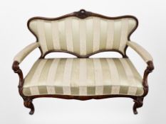 A late 19th century Danish carved and stained beech salon settee on cabriole legs,