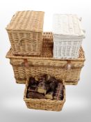 A wicker hamper and three baskets (one containing copper birch logs and pine cones)