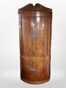 A 19th century Danish mahogany bow fronted standing corner cabinet,
