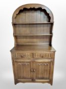 A reproduction oak linen fold dresser,