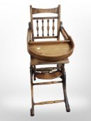 A reproduction beech child's adjustable high chair