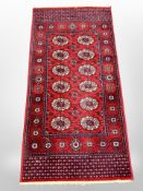 A machine made Bokhara rug 140 cm x 71 cm