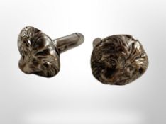 A pair of lion mask cuff links