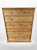 A contemporary pine six drawer chest,