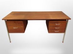 A 20th century Danish teak writing desk, fitted cupboards and drawers, raised on metal legs,