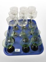A set of eight continental etched wine glasses and a further set of seven glasses