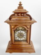 A reproduction walnut cased eight day bracket clock with brass and silvered dial,