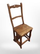 A reproduction oak metamorphic library step chair