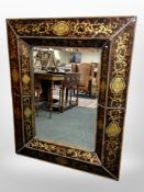 A contemporary cushion framed overmantel mirror in tortoiseshell effect frame,