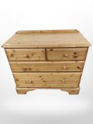 A contemporary pine four drawer chest,