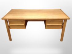 A 20th century Danish oak writing desk, fitted four drawers,