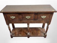 A George III style oak three drawer hall table,
