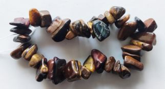 A Tiger's eye style bracelet together with costume jewellery earrings.