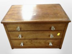 A Victorian three drawer chest with glass handles containing assorted spools of thread