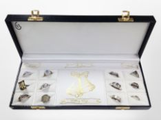 A display case containing 12 silver dress rings.