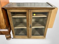 A glazed mahogany double door cabinet,