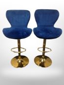 A pair of contemporary brass rise and fall stools