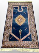 A machine-made Tabriz design rug on blue ground, 191cm x 98cm.