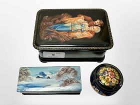 Three Russian hand-painted lacquer boxes, largest 13cm wide.