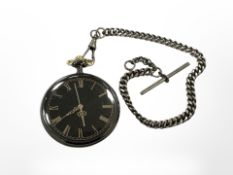 A pocket watch with black dial on chain