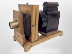 An early 20th century oak plate camera, with retailer's plaque for Doughty's Photographic Dealers,