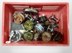 A crate of vintage and later fishing reels including Alvey,
