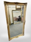 A gilt-framed overmantel mirror, 76cm x 136cm.