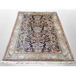 A silk piled Indian carpet on indigo ground,