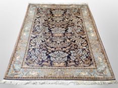 A silk piled Indian carpet on indigo ground,