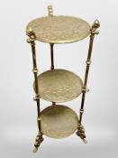 A brass three-tier plant stand,