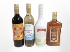 Four bottles of alcohol including Bellucci Amaretto, gingerbread mulled wine, white wine,