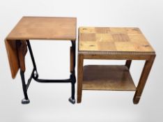 A two tier oak occasional table and a teak drop leaf table on castors
