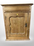 A 19th century pine single door cabinet,