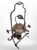 An Arts and Crafts wrought iron and copper kettle on stand, height 42cm.