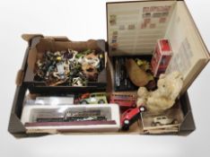 A box containing diecast cars and model train, farm animals, a vintage teddy bear, a stamp album,