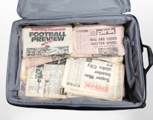 A suitcase containing football ephemera,