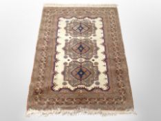 A Caucasian rug on beige ground,