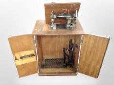 A Vesta hand sewing machine in cabinet