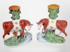 A pair of 19th century Staffordshire cow spill vases,